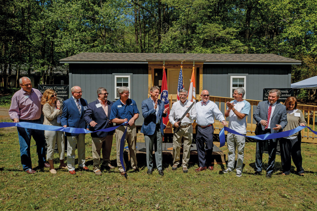 UT Martin and local officials cut the ribbon in front of a small slate gray building